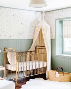 a baby's room with a crib, bed and rugs on the floor