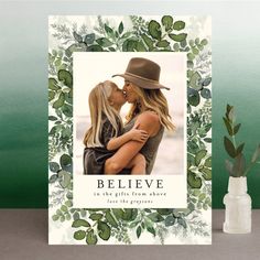 a card with an image of two women hugging and the words believe in front of them