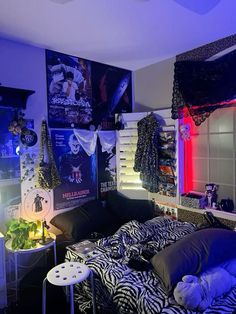 a bedroom with zebra print bedding and neon lights on the walls, along with posters