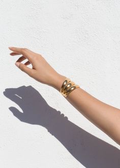 A thick cuff with a luxury, '70s feeling, but still comfortable to wear. Available in a double and single size for those who like to make a more subtle statement. Approximately 1.75'' Width, 2'' Height Available in 14K Gold Plate over Brass and Sterling Silver. Handmade in NYC In stock items ship in 1 to 4 days. Luxury Wide Band Gold Bangle, Modern Yellow Gold Wide Band Bracelet, Luxury Gold Wide Band Bangle, Classic Gold Open Cuff Bracelet, Timeless Open Cuff Bangle With Polished Finish, Modern Gold Cuff Bracelet With Wide Band, Modern Gold Wide Band Cuff Bracelet, Elegant Gold Cuff Bracelet With Thick Band, Luxury Gold Open Cuff Bangle