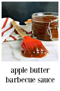 an apple butter barbecue sauce in a jar with a brush