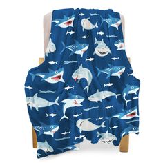 a blue blanket with sharks on it