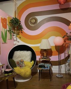 a living room filled with lots of furniture and decor on top of a hard wood floor