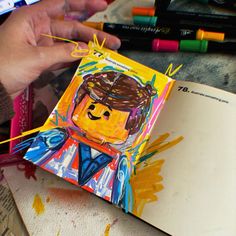 a child's artwork is being made with crayons and colored pencils