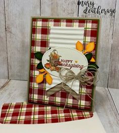 a close up of a greeting card on a table with a wooden background and oranges