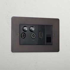 an electrical outlet with two switches on the wall