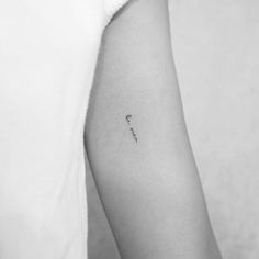 a woman's arm with a small tattoo on the left side of her arm