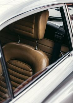 the interior of a car with brown leather seats