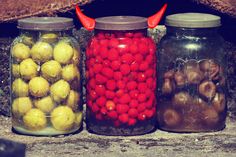 three jars filled with different types of food