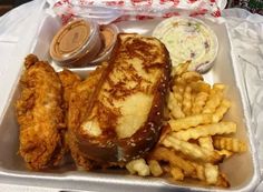 a plastic container filled with french fries and chicken