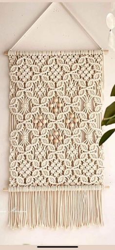 a white wall hanging with fringes on it