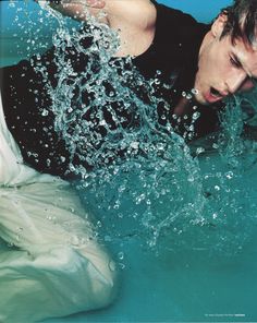 a young man is swimming in the water