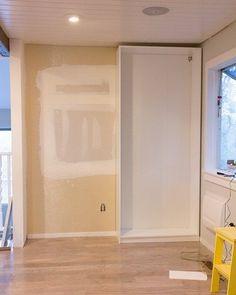 an empty room with white paint on the walls and wood flooring being painted yellow