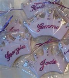 some pink and white ornaments with purple writing on them are wrapped in clear cellophane