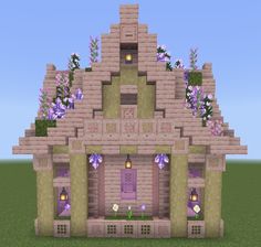 a house made out of bricks with flowers on the roof