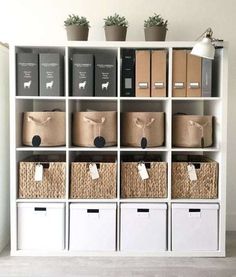 a white bookcase filled with lots of boxes and bins