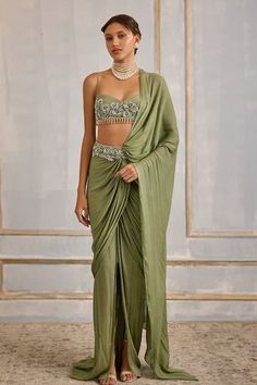 Sage green pre-draped saree with sequin, cutdana, bead embroidered waistband and detachable drape. Paired with sleeveless embroidered padded blouse. - Aza Fashions Fitted Green Draped Sets, Green Draped Silk Sets, Green Bollywood Draped Set, Festive Green Draped Sets, Green Draped Sets With Dupatta, Pre-draped Silk Sets, Green Draped Party Sets, Green Draped Sets With Zari Work, Green Designer Wear Pre-draped Saree