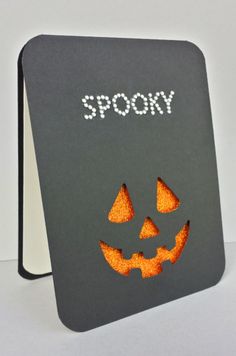 a black and gray sign with an orange jack - o'- lantern face on it