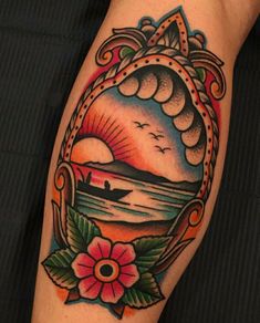 a colorful tattoo design on the arm of a person with a boat in the water