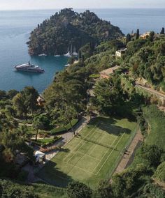 an aerial view of a tennis court in the middle of a large body of water