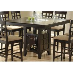 a dining room table with chairs and a wine rack