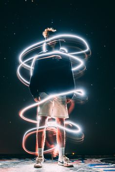 a man standing in front of some lights with his back turned to the camera,