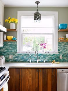 a kitchen with a sink, dishwasher and window