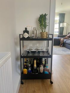 a bar cart filled with bottles and glasses