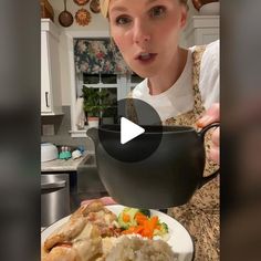 a woman holding a bowl full of food