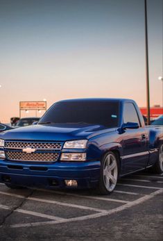 a blue pickup truck parked in a parking lot