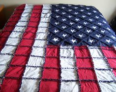 an american flag quilt on top of a bed