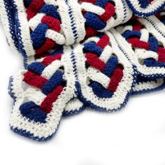 crocheted red, white and blue blanket laying on top of each other