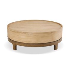 a round wooden table sitting on top of a white floor