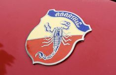 an emblem on the side of a red car