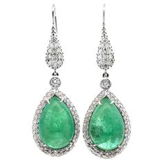 These brand-new Modern Cabochon Emerald & Diamond Drop Earrings feature two stunning pear-shaped cabochon emeralds totaling 24.0 carats, radiating vibrant green hues. Each emerald is framed and accented by 148 round brilliant-cut diamonds, totaling 2.30 carats (H-I color, SI clarity), adding an exquisite sparkle. Crafted with precision, these 2-inch-long drop earrings exude elegance and luxury, making them a show-stopping accessory for any formal occasion. Weight: 16.2 grams. Luxury Elegant Cluster Gemstone Earrings, Luxury Fine Jewelry Earrings With Accent Stones, Luxury Formal Earrings With Stone Setting, Luxury Diamond Earrings With Gemstones, Luxury Formal Earrings With Rectangular Stone, Earring Video, Green Hues, Long Drop Earrings, Moonstone Earrings