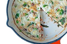 an omelet with cheese and spinach in a cast iron skillet on a white background