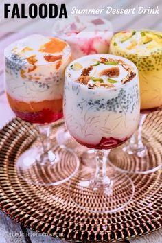 three glasses filled with different colored desserts on top of a table next to each other