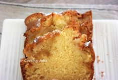 slices of pound cake sitting on top of a white plate with icing and powdered sugar