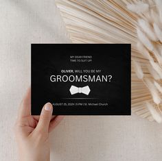 a person holding up a card that says, my dear friend will you be my groomsman?