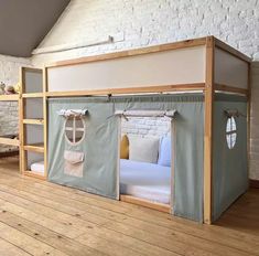 a room with bunk beds made out of canvass and wooden flooring is shown