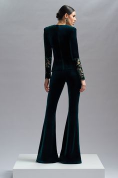 CRISTALLINI VELVET VOGUE pants are a combination of style and comfort, perfect for adding a touch of elegance and sophistication to any outfit.    Velvet flared pants    Hook and fastenings zip on the side    Dry clean    Shown color: Black, Green    Made In EU Vogue Pants, Velvet Flared Pants, Velvet Flare Pants, Corset Skirt, Velvet Flares, Luxury Wear, Couture Tops, The Velvet, Flared Pants