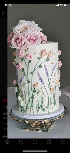 a white and pink cake with flowers on it