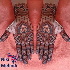 two hands with hendi designs on them and the words niki mehndi written below