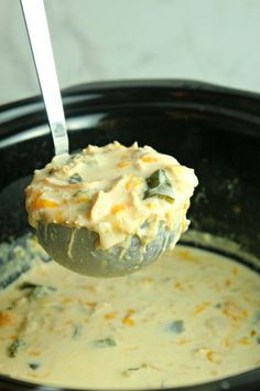 a spoon full of soup in a crock pot