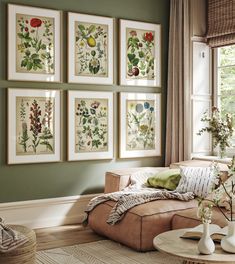 a living room filled with furniture and paintings on the wall above it's windows