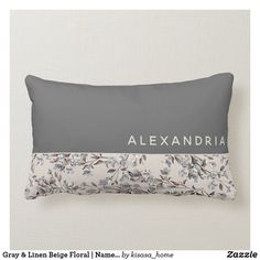 a gray and white floral pillow with the name alexandria on it's front side