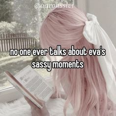 a girl with pink hair is reading a book and has her head turned to the side