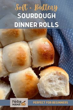 soft and buttery sourdough dinner rolls on a cutting board with a blue towel