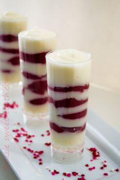 three desserts with red and white frosting on a tray