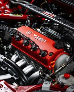 the engine compartment of a red sports car